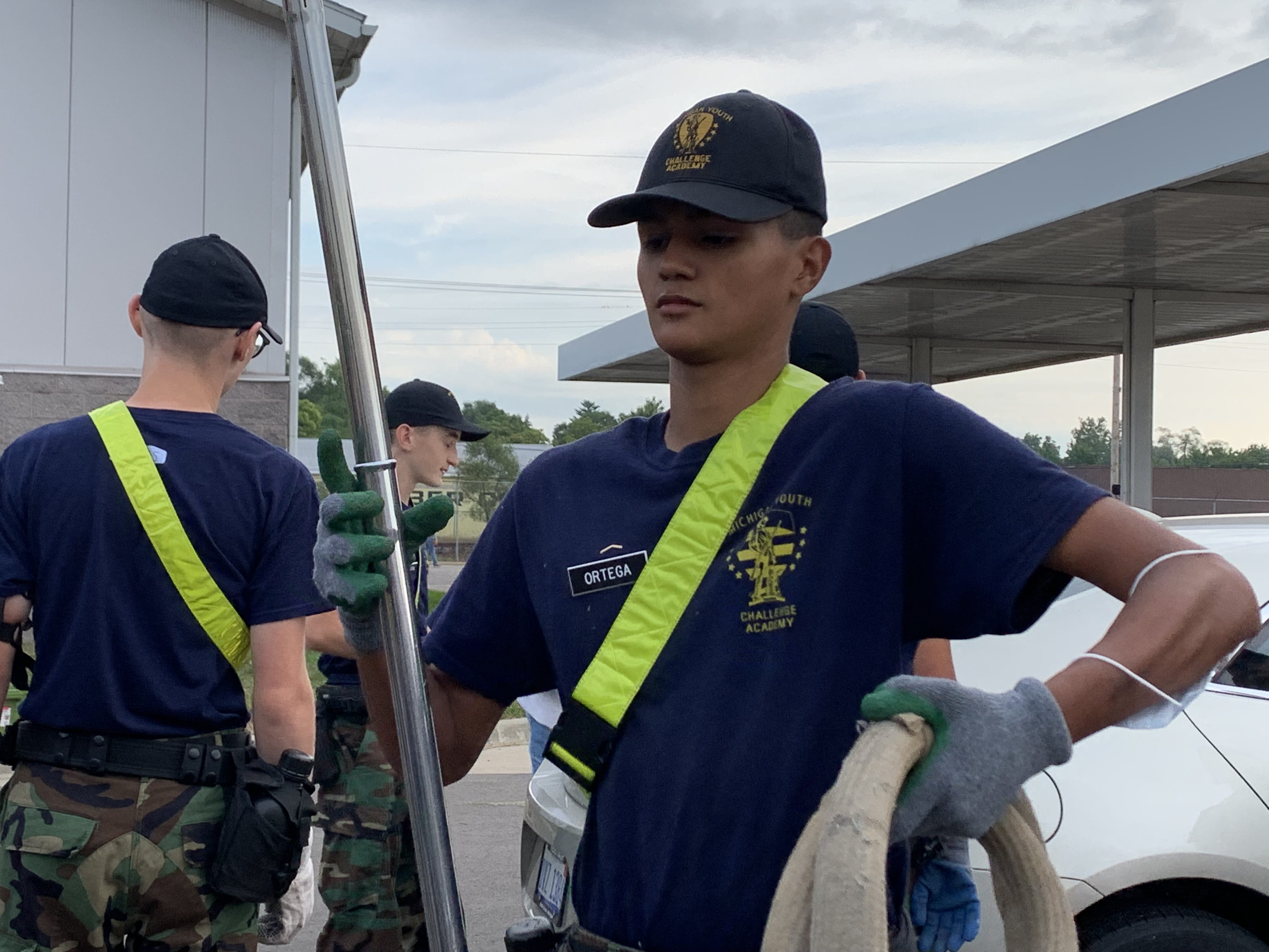MYCA men outdoors carrying equipment