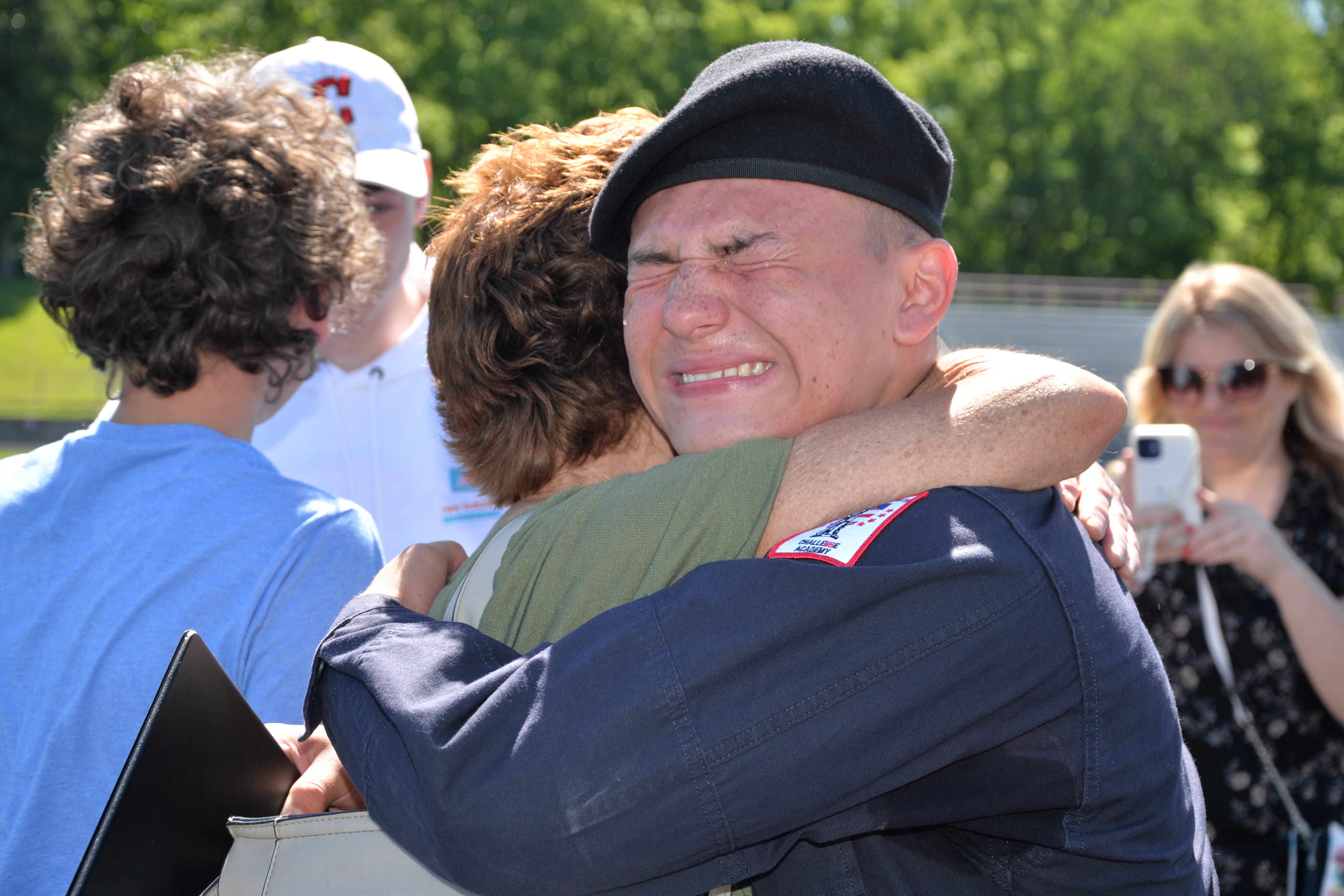 Cadet hugging woman on graduation day
