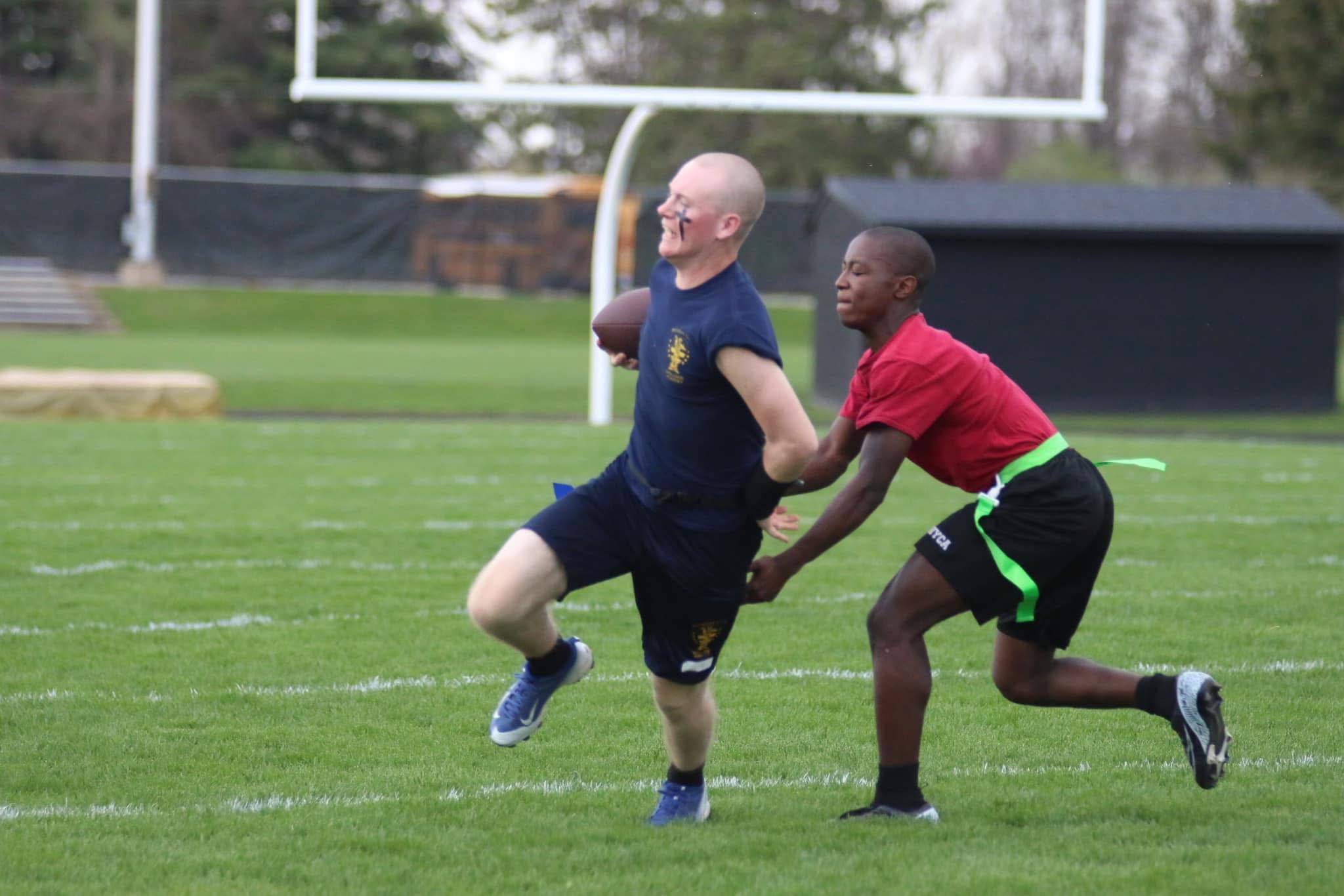 two cadets playing flag football
