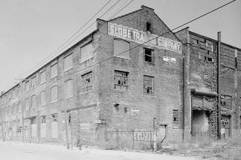 black and white photo of the dilapidated Globe Building, with broken windows and graffiti