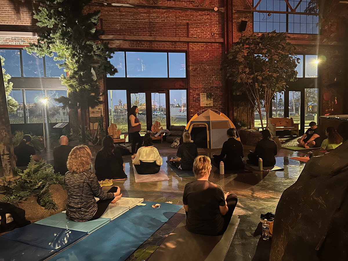group doing yoga class inside Outdoor Adventure Center