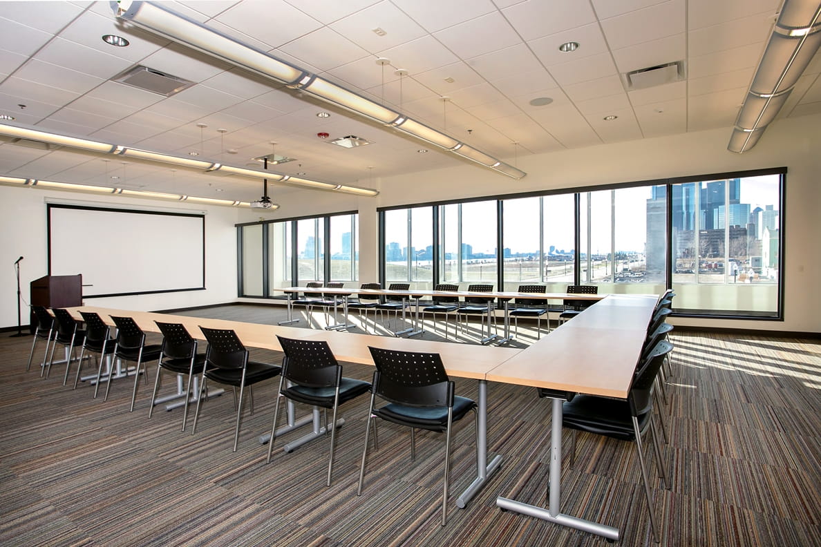 Outdoor Adventure Center Forest Room, set up for a meeting, with view of Detroit River.