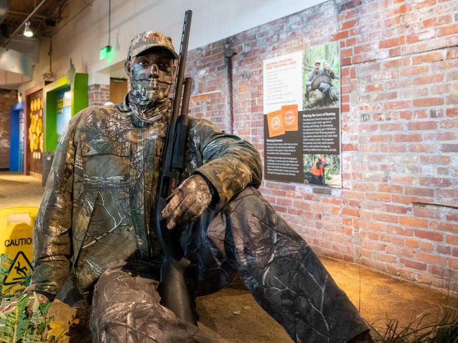 life-size figure of hunter in camouflage gear
