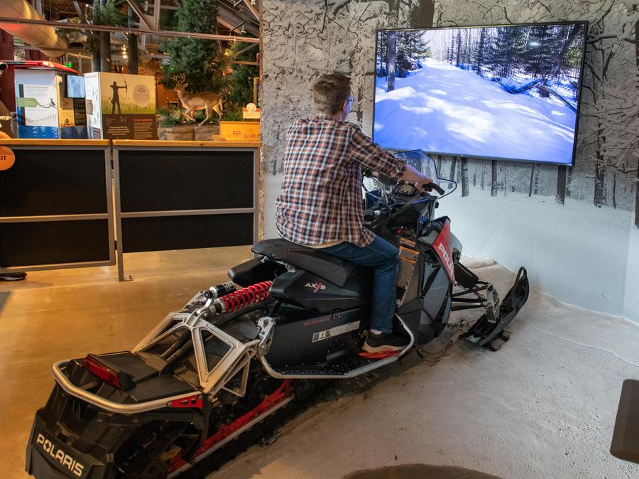 man uses OAC snowmobiling simulator