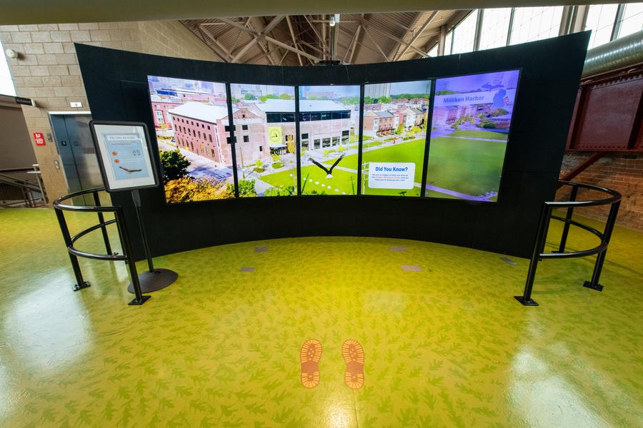 two young ladies try out "fly like an eagle" simulator
