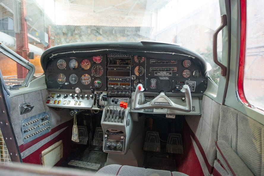 inside view of Outdoor Adventure Center airplane, with instrument panel and controls