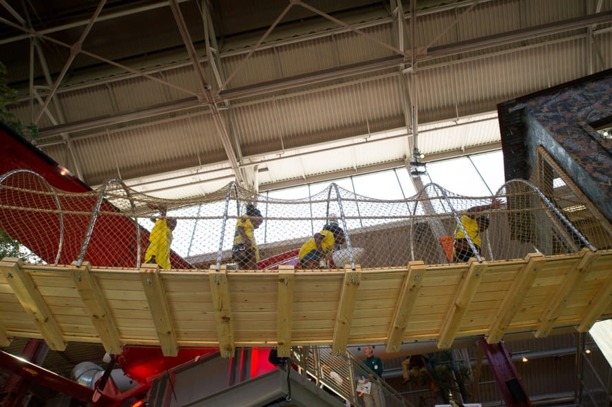 kids cross Outdoor Adventure Center suspension bridge to hunting blind, seen from below bridge