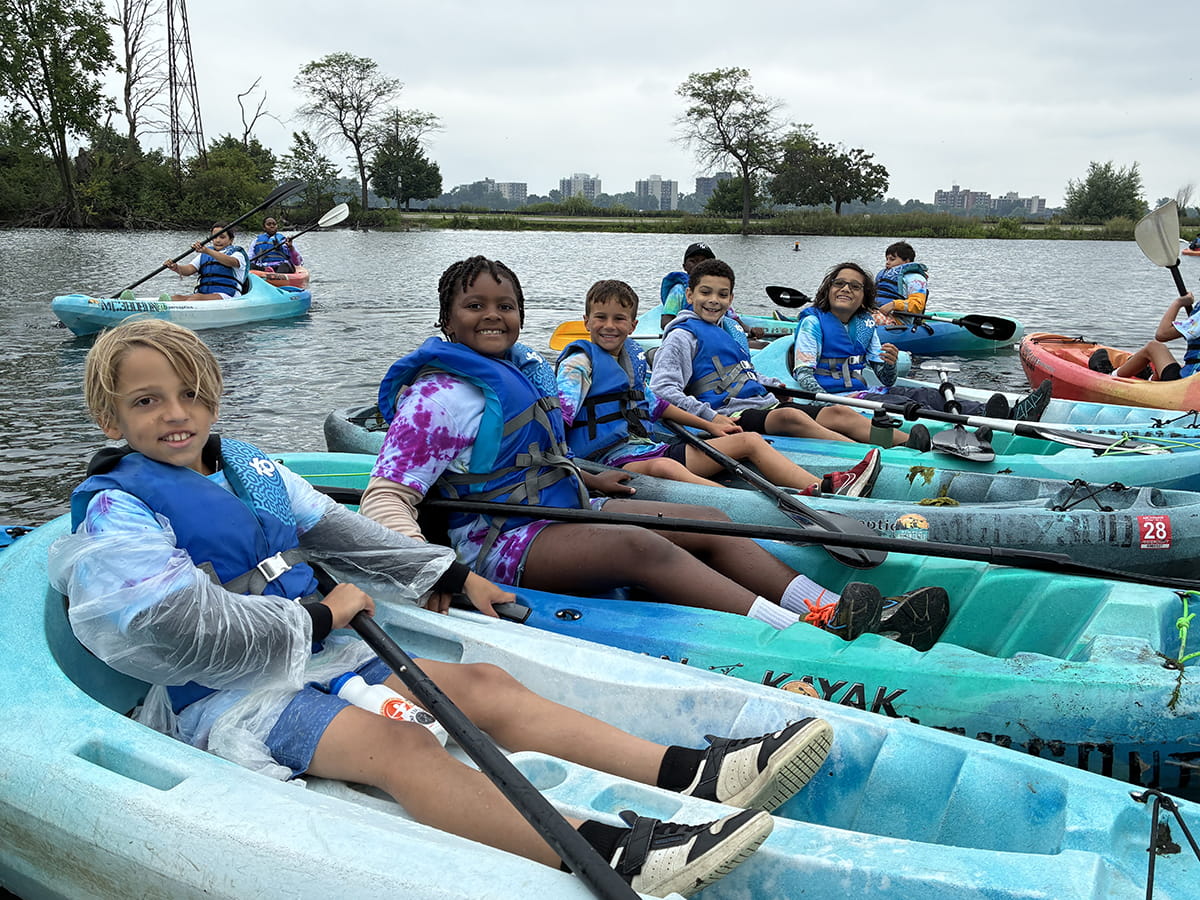 group of young people in kayaks