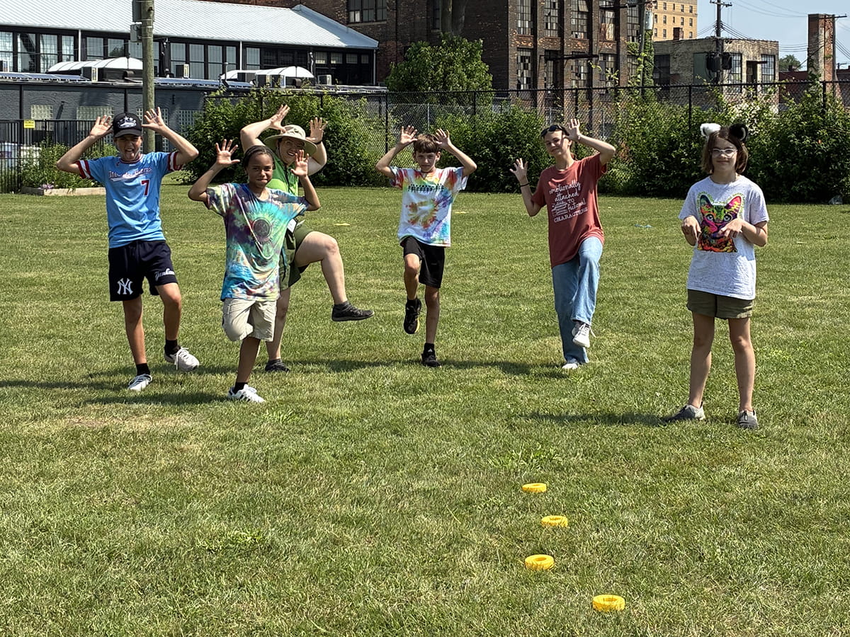 group of summer camp attendees playing game on OAC lawn