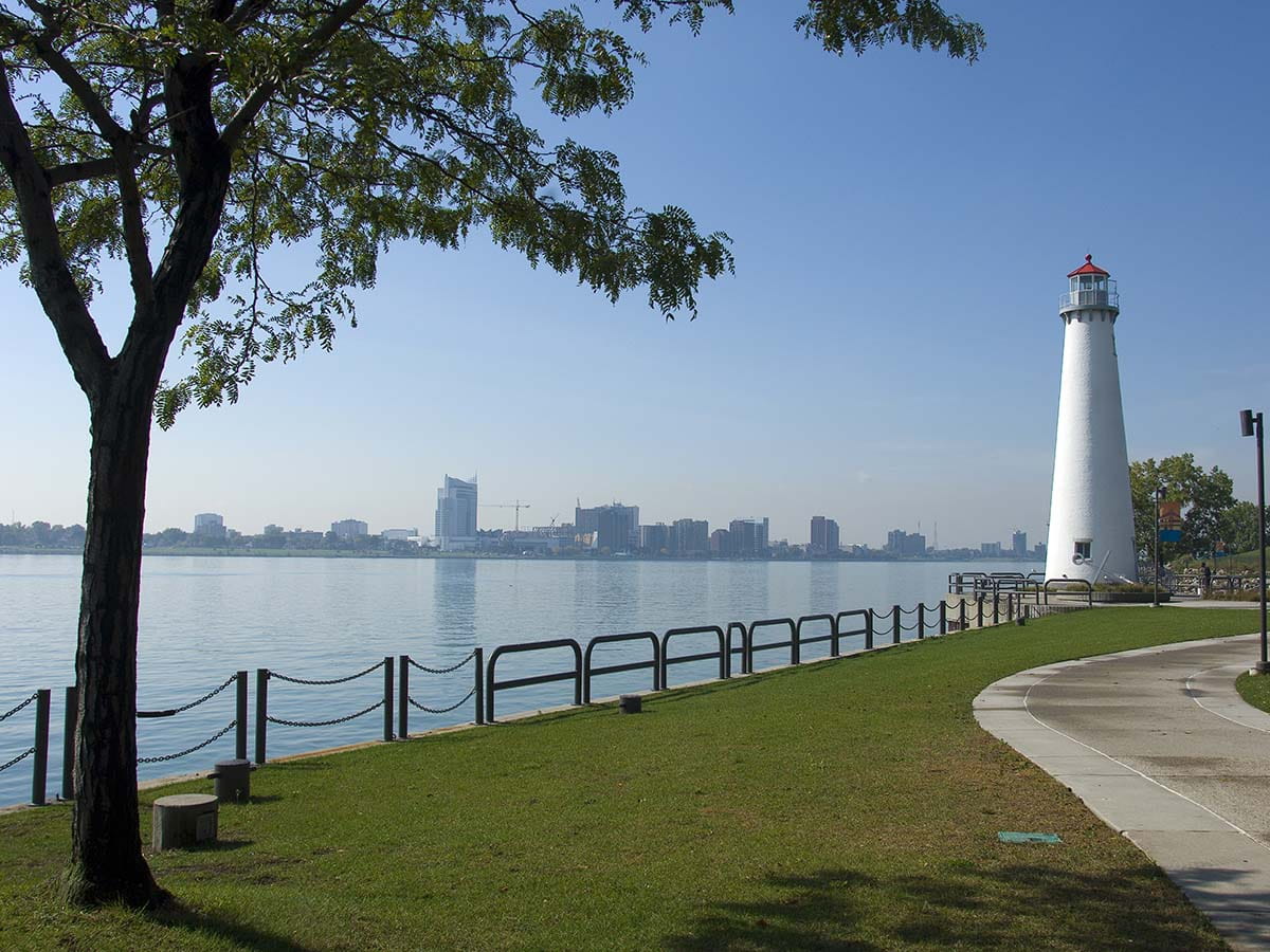 Scenic view of Detroit River, skyline and lighthouse from Milliken State Park