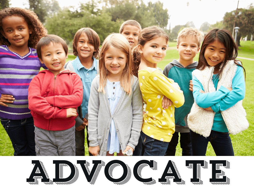 a group of children standing outside smiling for the camera, over the word Advocate.