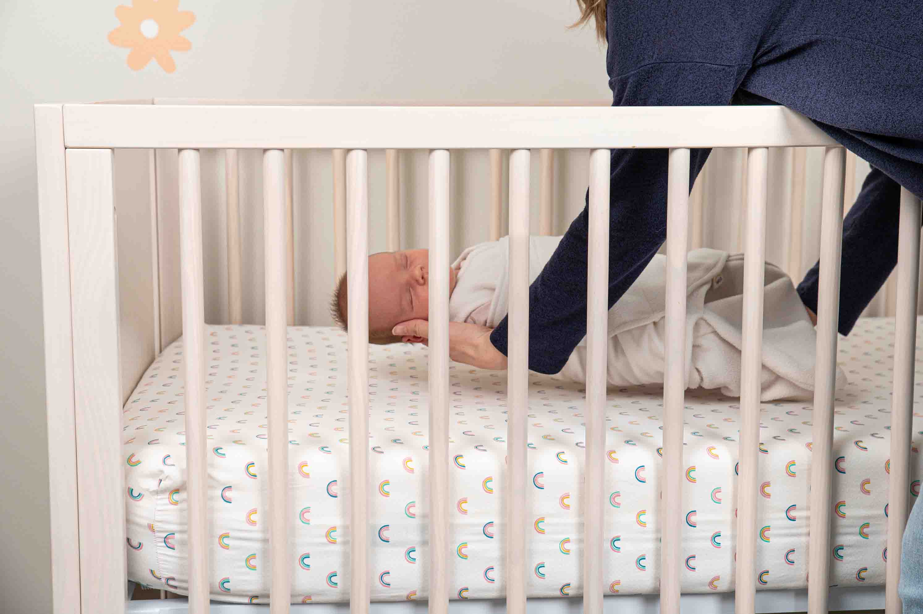 a baby being placed in a crib 