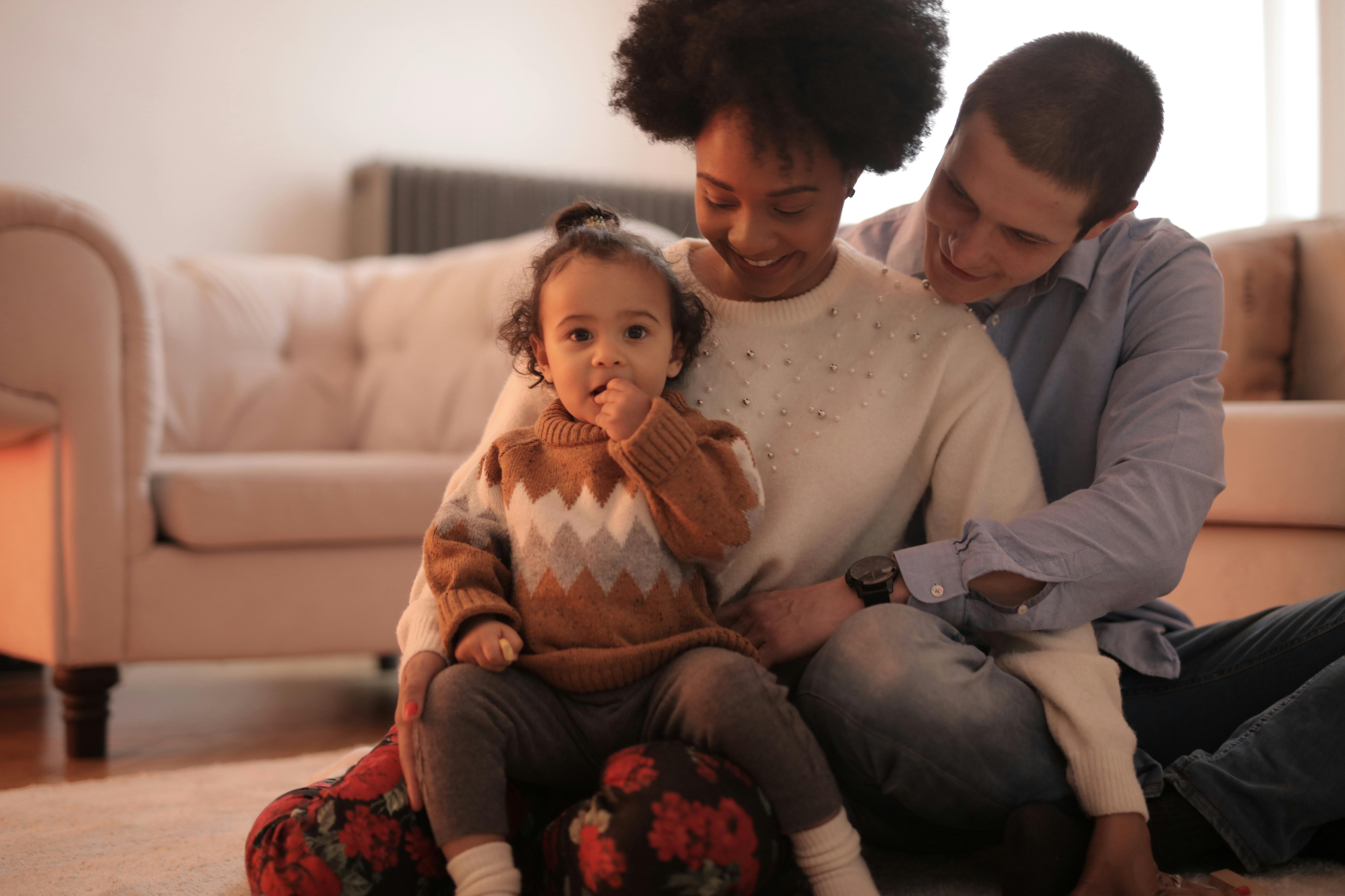 Image of a family sitting on the floor