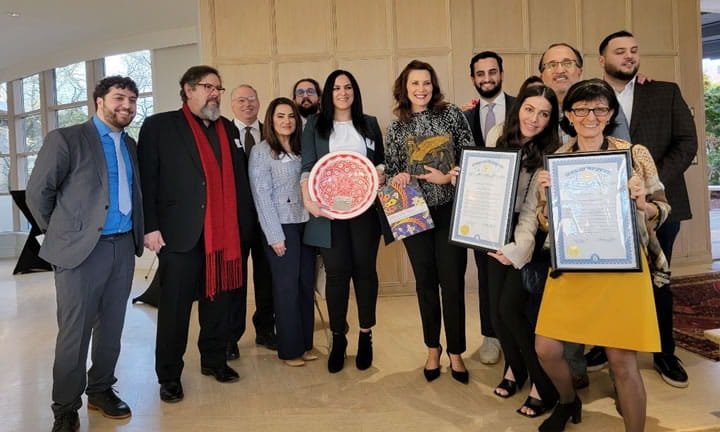CMEAA members posing, some holding proclamations, with Governor Whitmer