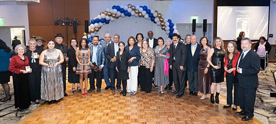 HLCOM's 2025 Latino Legacy Leaders at gala standing on a dancefloor in front of a balloon arch