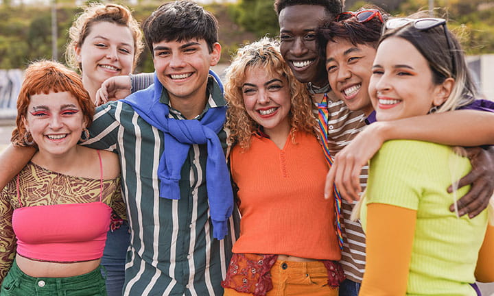 Twelve LGBTQ+ commissioners smiling for a picture