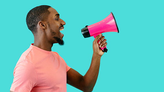 a man talking into a megaphone to represent spreading the message