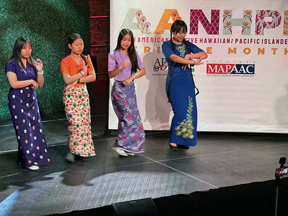 Four performers dancing on stage at Asian American, Native Hawaiin, and Pacific Islander month celebration