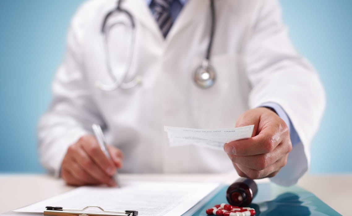 Stock Image of Doctor Signing Paper