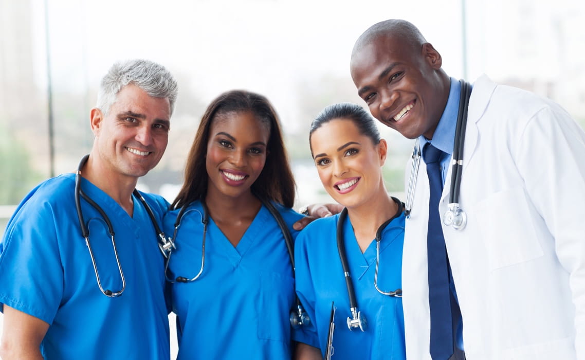 Image of four health professionals smiling