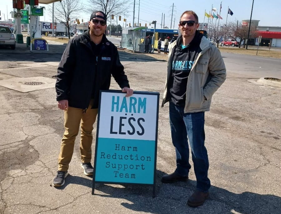 2 Harm Reduction Experts by sign