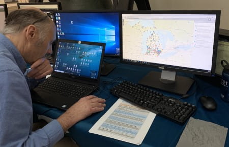 Man working on GIS project on laptop computer at Michigan GIS Day event in 2019