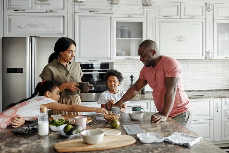 A family around the kitchen counter.
