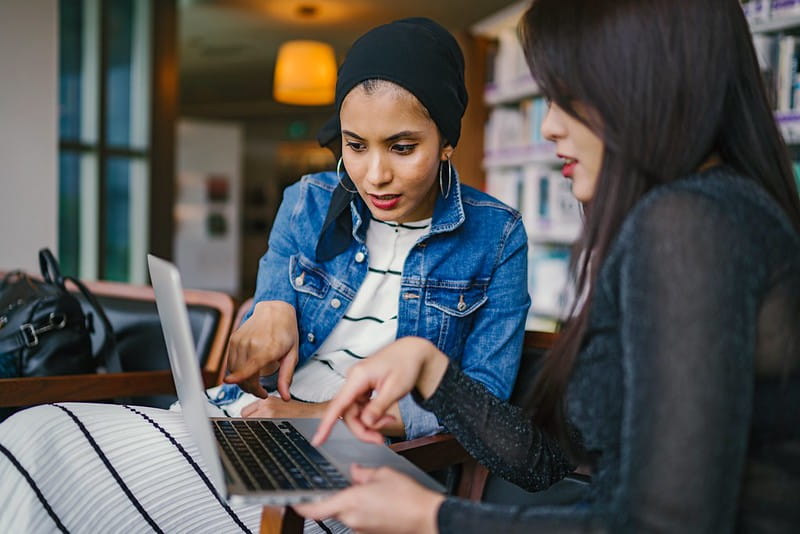 Two women working on a computer