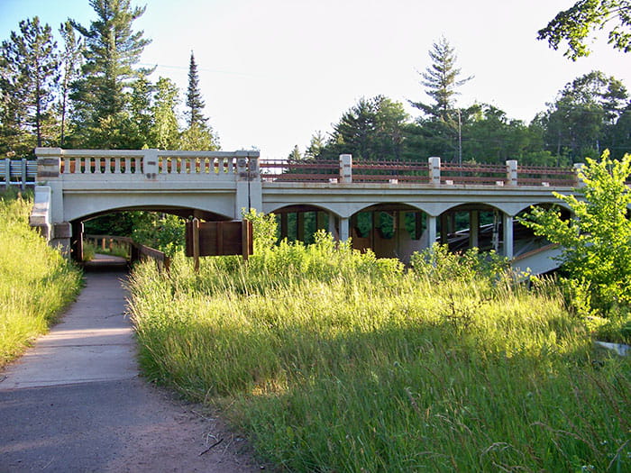 bridge over river and paved trail