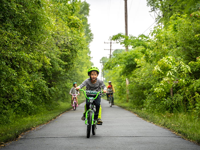 famiy riding bikes on paved trail