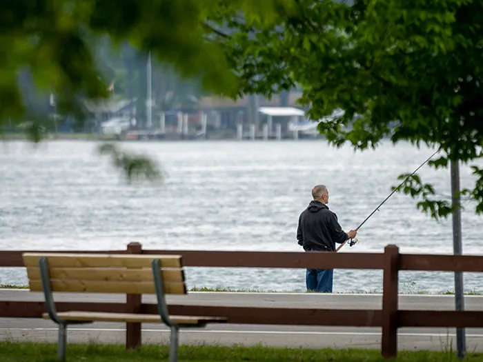 man fishing from riverfront