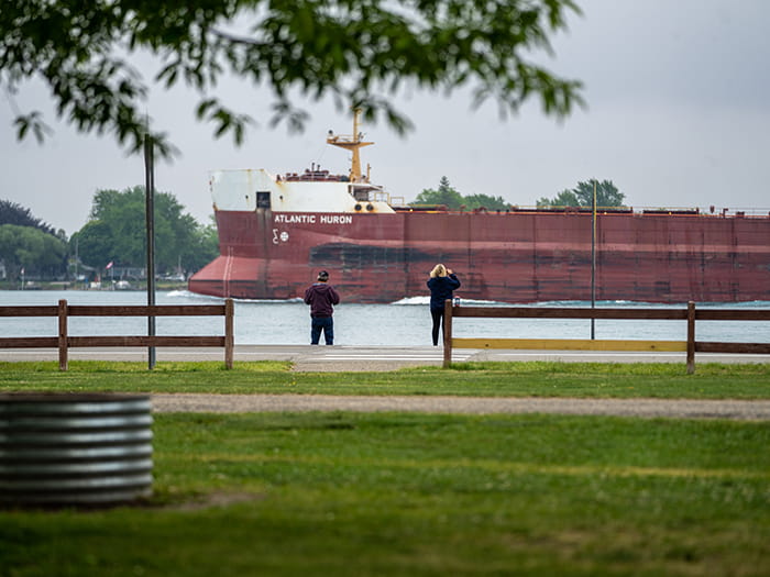 two visitors looking at freighters