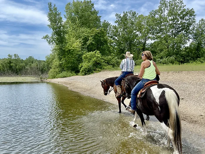 riders riding the edge of the lake