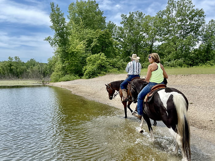 riders riding the edge of the lake