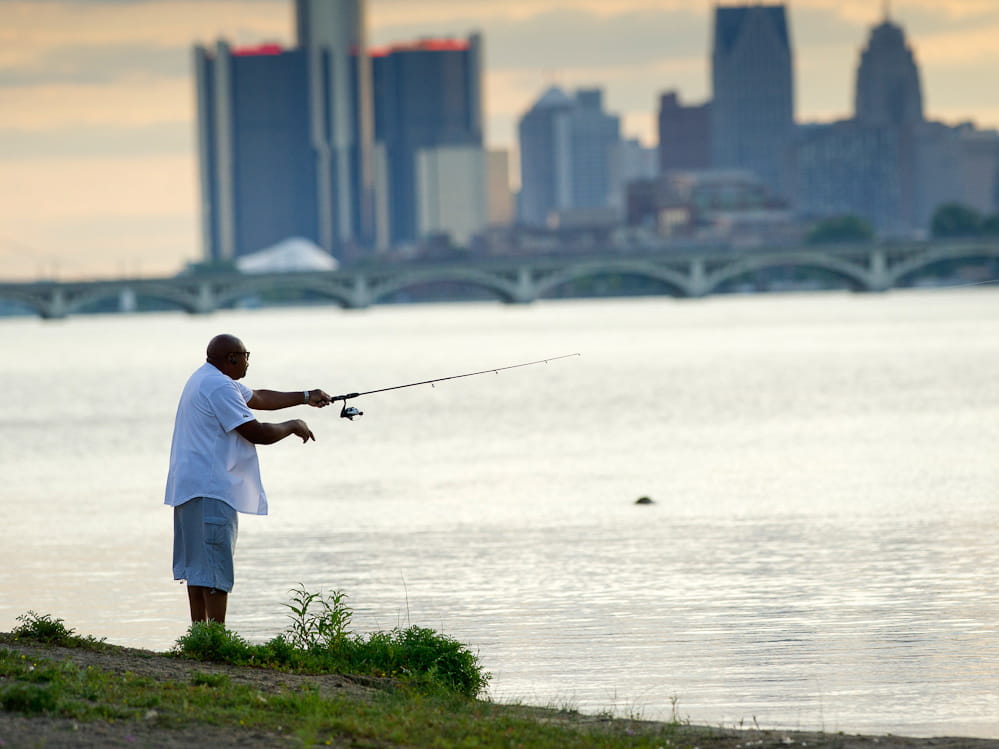 man shoreline fishing