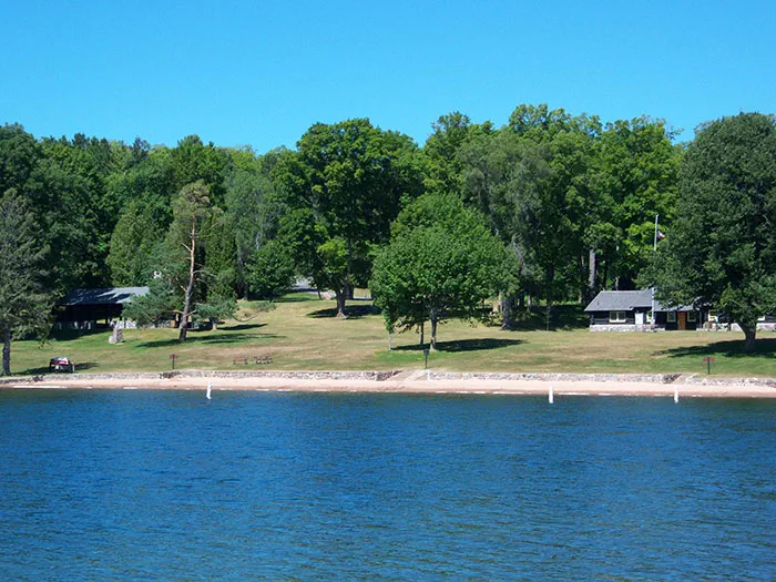 shoreline with trees and structure in background