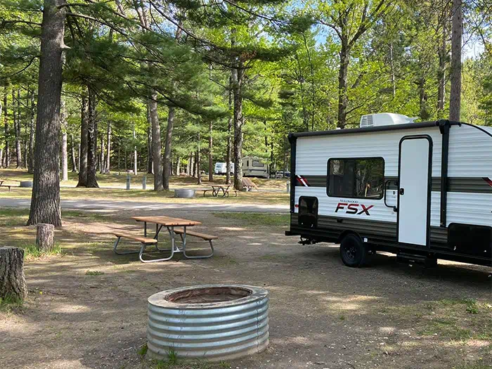 campground sites with fire pit and camper