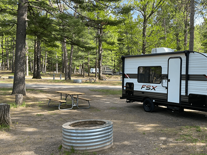campground sites with fire pit and camper