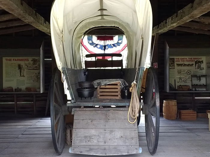 covered buggy inside historic barn