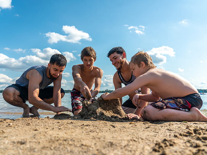 four kids playing in sand