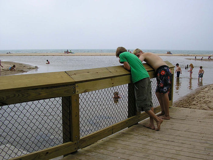 kids looking at water over railing
