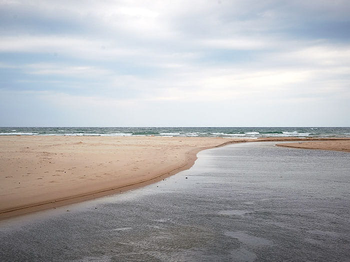 sandy outlet leading to Lake Michigan by Robert Neumann Instagram robertneumann