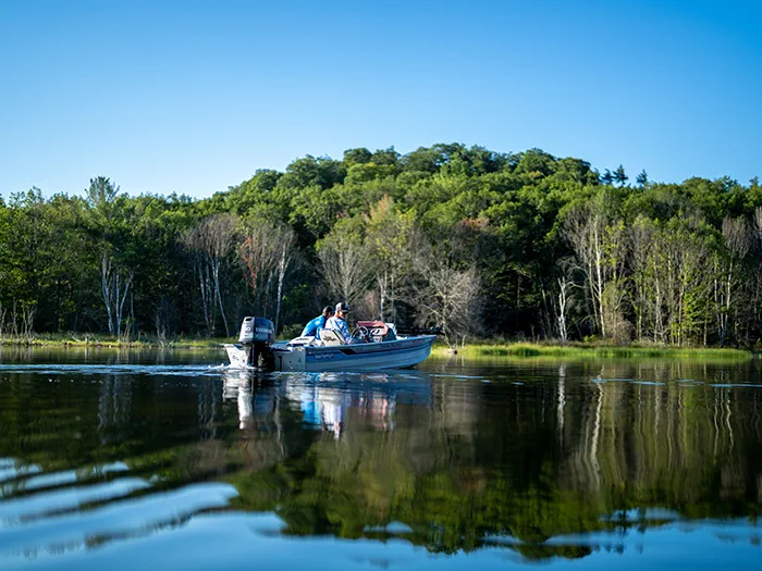 two men fishing in motor boat