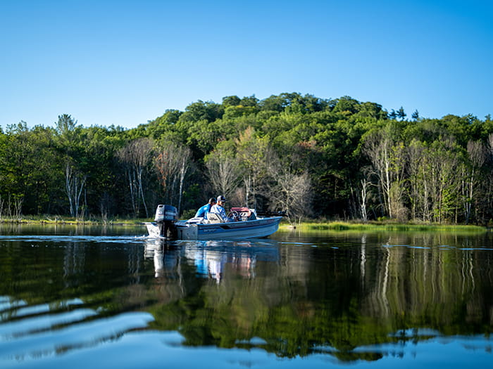two men fishing in motor boat