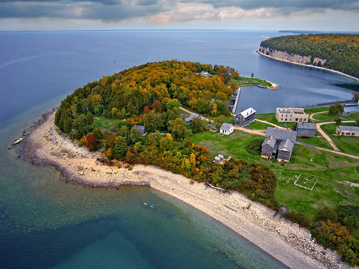 aeriel view of land and water with historic village