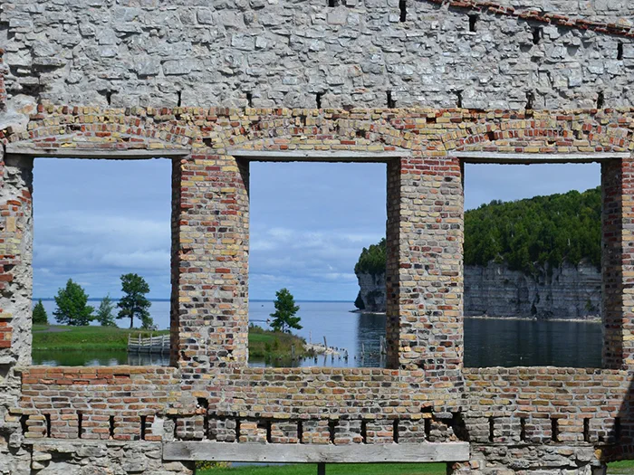 brick wall with windows you can see through to water