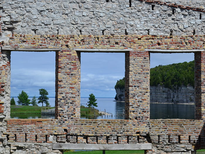 brick wall with windows you can see through to water