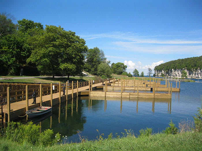 docks in harbor with cliffs in background