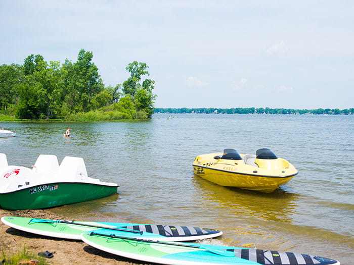 boat and stand up paddleboard along shoreline