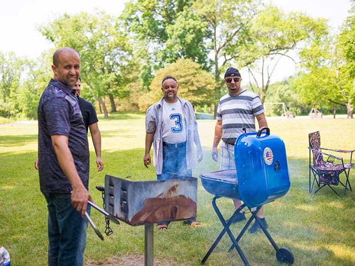 visitors grilling in grassy area